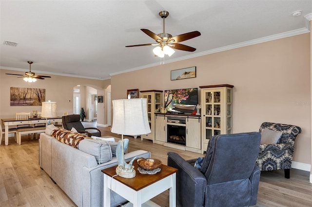 3809 Arlington Ridge Blvd, Leesburg, FL 34748 - living area with a ceiling fan, arched walkways, light wood-style floors, and crown molding