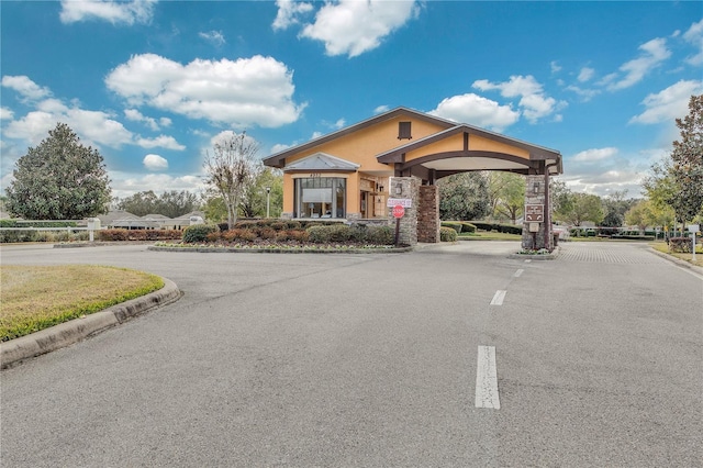 3809 Arlington Ridge Blvd, Leesburg, FL 34748 - view of asphalt street featuring curbs and a gated entry