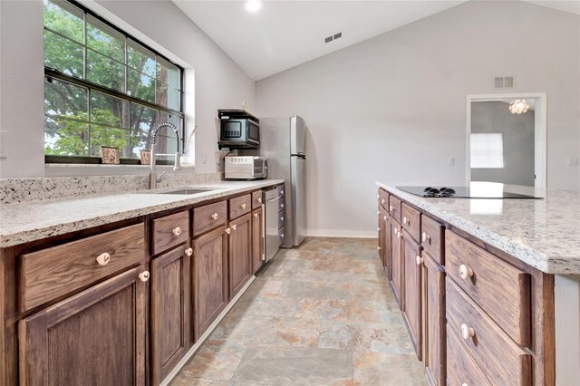 10330 Dwights Rd, Clermont, FL 34714 - kitchen featuring stainless steel appliances, a sink, stone finish floors, light stone countertops, and baseboards