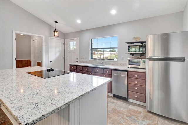 10330 Dwights Rd, Clermont, FL 34714 - kitchen with appliances with stainless steel finishes, a sink, lofted ceiling, light stone counters, and decorative light fixtures
