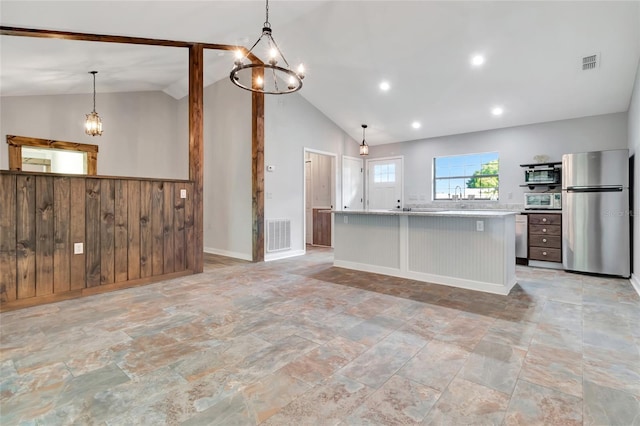 10330 Dwights Rd, Clermont, FL 34714 - kitchen featuring freestanding refrigerator, vaulted ceiling, a chandelier, light countertops, and hanging light fixtures