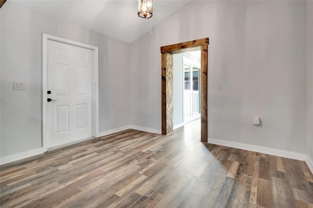 10330 Dwights Rd, Clermont, FL 34714 - spare room featuring lofted ceiling, baseboards, and wood finished floors