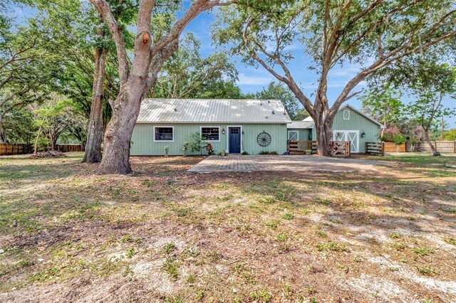 10330 Dwights Rd, Clermont, FL 34714 - view of front of house with metal roof and a deck