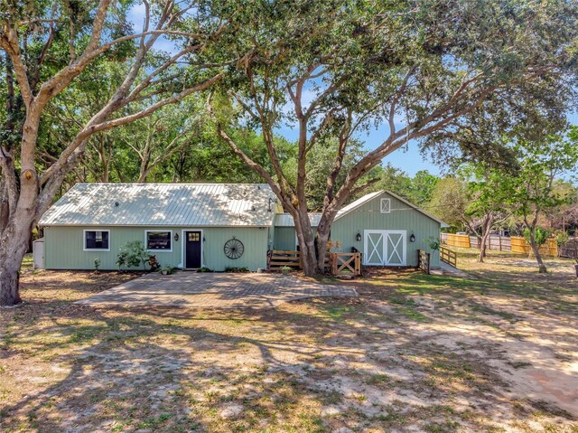 10330 Dwights Rd, Clermont, FL 34714 - view of front facade featuring metal roof and an outdoor structure