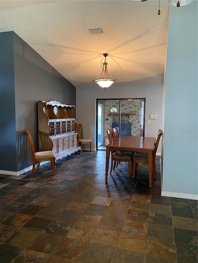 901 Baylor Dr, Deltona, FL 32725 - dining room with baseboards, stone tile floors, and a textured ceiling