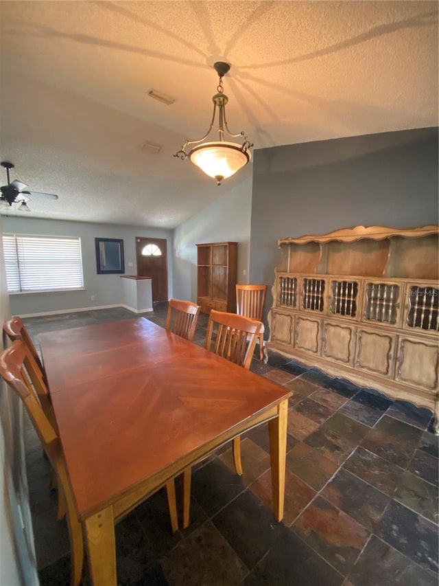 901 Baylor Dr, Deltona, FL 32725 - dining space with a textured ceiling, stone finish floors, and vaulted ceiling