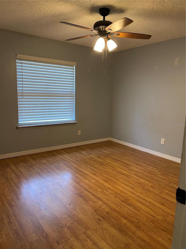 901 Baylor Dr, Deltona, FL 32725 - spare room featuring a textured ceiling, wood finished floors, ceiling fan, and baseboards