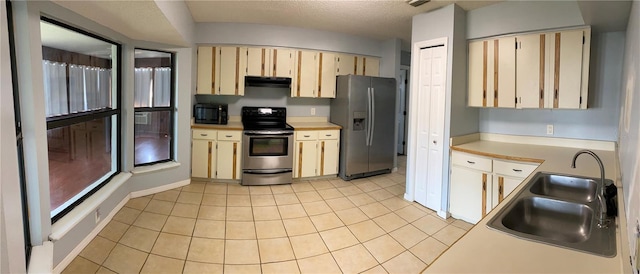 901 Baylor Dr, Deltona, FL 32725 - kitchen featuring appliances with stainless steel finishes, under cabinet range hood, a sink, light countertops, and a textured ceiling