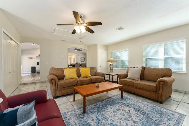 40140 Palm St, Lady Lake, FL 32159 - living area featuring a ceiling fan, light tile patterned floors, baseboards, and arched walkways