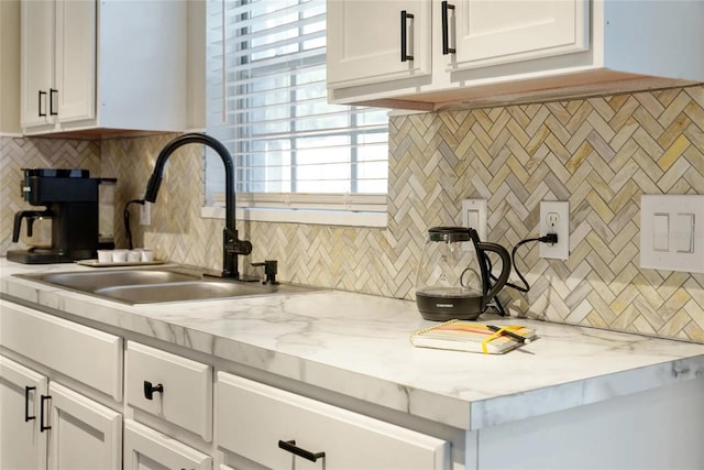 40140 Palm St, Lady Lake, FL 32159 - kitchen featuring a sink, tasteful backsplash, white cabinetry, and light stone countertops