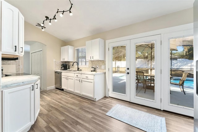 40140 Palm St, Lady Lake, FL 32159 - kitchen with french doors, dishwasher, tasteful backsplash, white cabinets, and lofted ceiling
