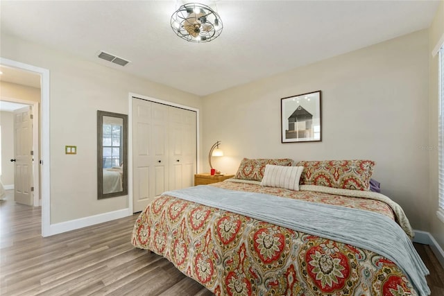 40140 Palm St, Lady Lake, FL 32159 - bedroom featuring baseboards, wood finished floors, and a closet