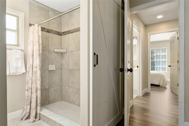 40140 Palm St, Lady Lake, FL 32159 - bathroom with a tile shower, baseboards, ensuite bathroom, and wood finished floors