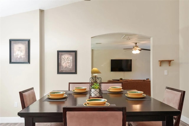 40140 Palm St, Lady Lake, FL 32159 - dining room featuring a ceiling fan, arched walkways, baseboards, and wood finished floors