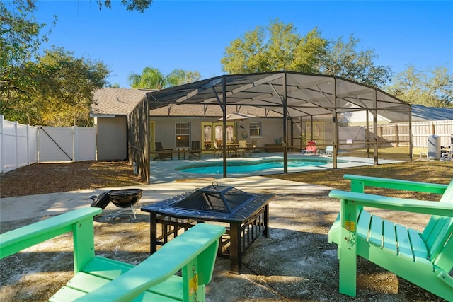 40140 Palm St, Lady Lake, FL 32159 - view of pool with a fire pit, a fenced backyard, a patio area, and glass enclosure