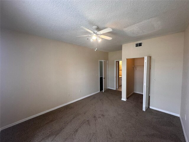 5560 Metrowest Blvd Unit 3-204, Orlando, FL 32811 - unfurnished bedroom featuring dark colored carpet, baseboards, a closet, a textured ceiling, and a ceiling fan