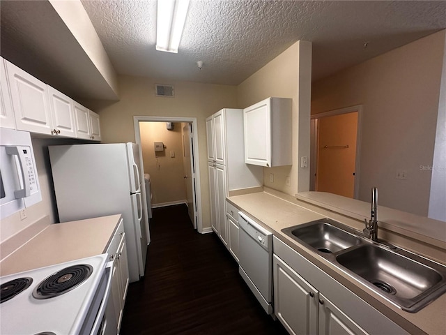 5560 Metrowest Blvd Unit 3-204, Orlando, FL 32811 - kitchen featuring white appliances, a sink, dark wood-style flooring, a textured ceiling, and white cabinets