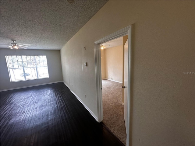 5560 Metrowest Blvd Unit 3-204, Orlando, FL 32811 - empty room featuring a ceiling fan, baseboards, a textured ceiling, and dark wood finished floors