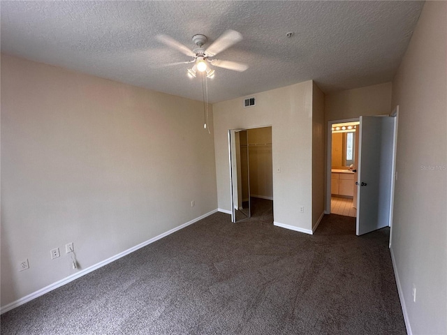 5560 Metrowest Blvd Unit 3-204, Orlando, FL 32811 - unfurnished bedroom with dark colored carpet, baseboards, a textured ceiling, a ceiling fan, and a closet