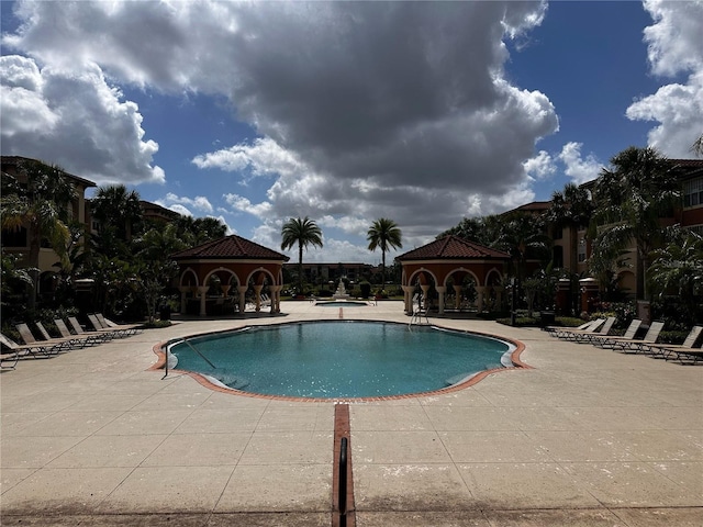 5560 Metrowest Blvd Unit 3-204, Orlando, FL 32811 - community pool featuring a patio