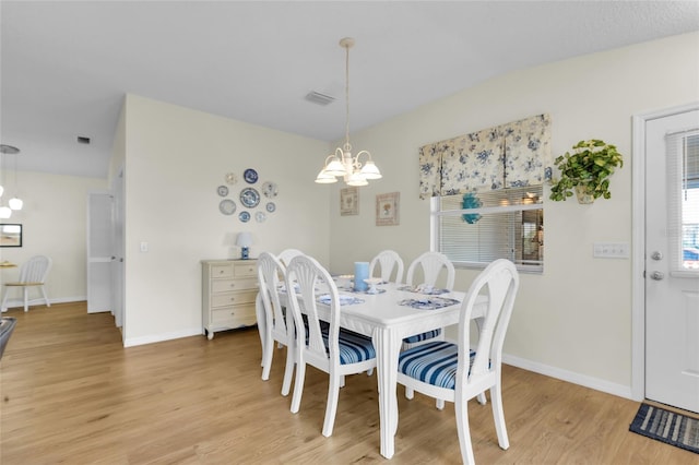 2111 Thornton Ter, The Villages, FL 32162 - dining area featuring a chandelier, light wood-style flooring, and baseboards