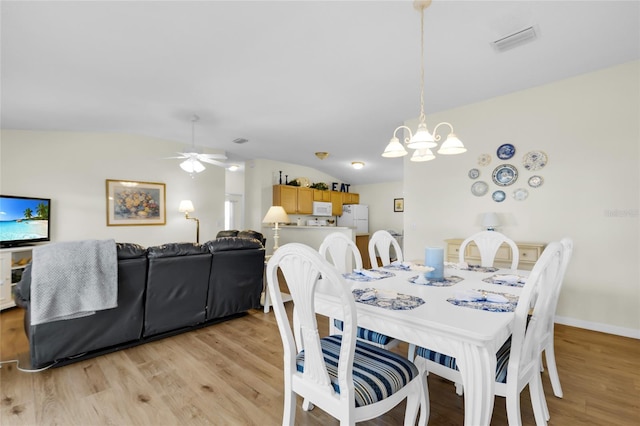 2111 Thornton Ter, The Villages, FL 32162 - dining room featuring a ceiling fan, light wood-type flooring, a chandelier, and baseboards
