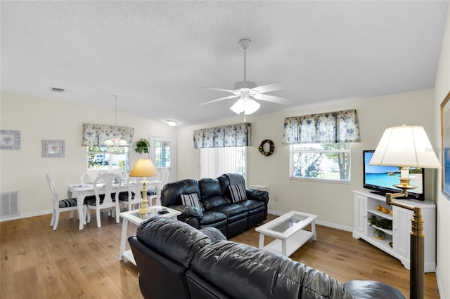 2111 Thornton Ter, The Villages, FL 32162 - living room featuring plenty of natural light, ceiling fan, light wood finished floors, lofted ceiling, and baseboards
