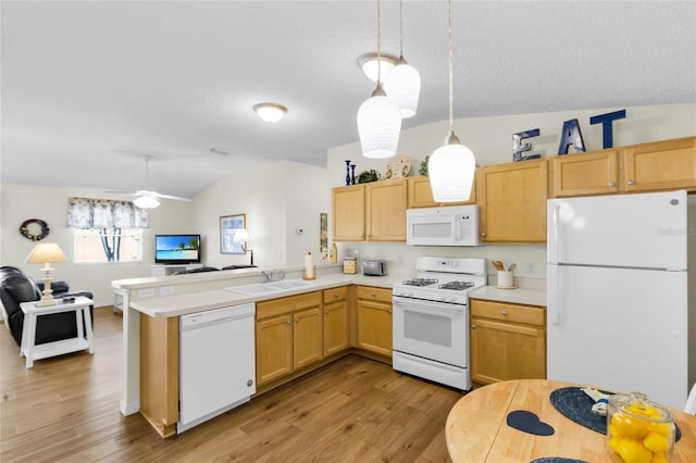 2111 Thornton Ter, The Villages, FL 32162 - kitchen with white appliances, a sink, light wood-style flooring, a peninsula, and light countertops