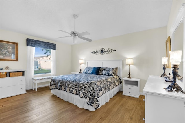 2111 Thornton Ter, The Villages, FL 32162 - bedroom with light wood finished floors, ceiling fan, and baseboards