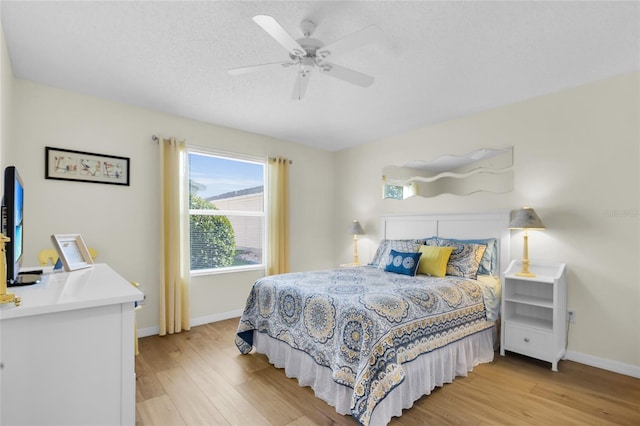 2111 Thornton Ter, The Villages, FL 32162 - bedroom featuring light wood-type flooring, baseboards, and ceiling fan