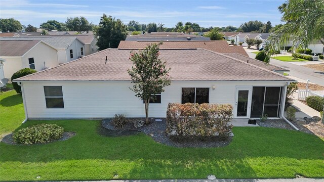 2111 Thornton Ter, The Villages, FL 32162 - back of house with a shingled roof, a yard, and a residential view