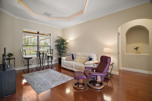 21206 Canoe Pass St, Clermont, FL 34715 - living area featuring hardwood / wood-style flooring, a raised ceiling, baseboards, ornamental molding, and arched walkways