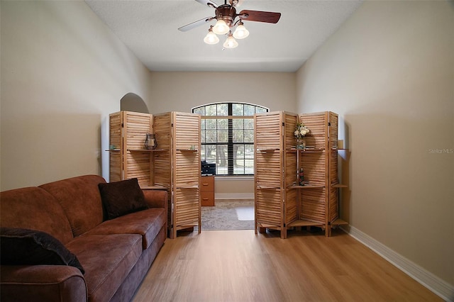 21206 Canoe Pass St, Clermont, FL 34715 - living area with light wood-type flooring, ceiling fan, and baseboards