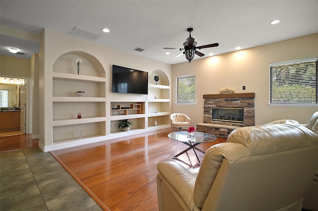 21206 Canoe Pass St, Clermont, FL 34715 - living area with a textured ceiling, healthy amount of natural light, a ceiling fan, built in features, and recessed lighting