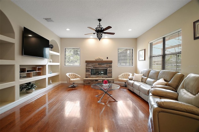 21206 Canoe Pass St, Clermont, FL 34715 - living room featuring plenty of natural light, ceiling fan, wood finished floors, built in features, and a textured ceiling