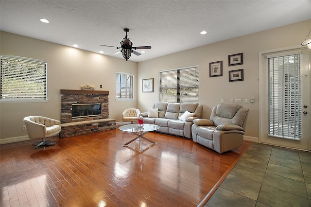 21206 Canoe Pass St, Clermont, FL 34715 - living room with a ceiling fan, wood finished floors, baseboards, recessed lighting, and a fireplace