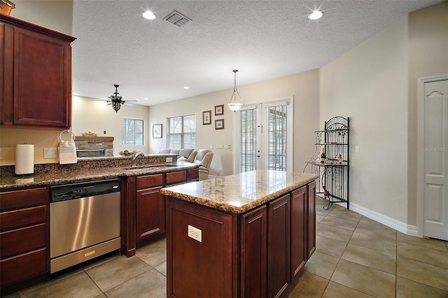 21206 Canoe Pass St, Clermont, FL 34715 - kitchen with dishwasher, a sink, a ceiling fan, dark brown cabinets, and light tile patterned flooring