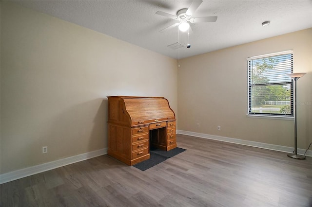 21206 Canoe Pass St, Clermont, FL 34715 - unfurnished office featuring wood finished floors, ceiling fan, baseboards, and a textured ceiling