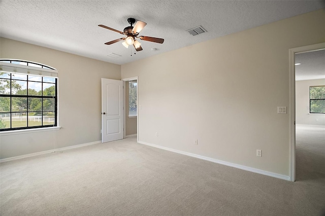 21206 Canoe Pass St, Clermont, FL 34715 - unfurnished bedroom featuring light colored carpet, baseboards, a textured ceiling, and ceiling fan