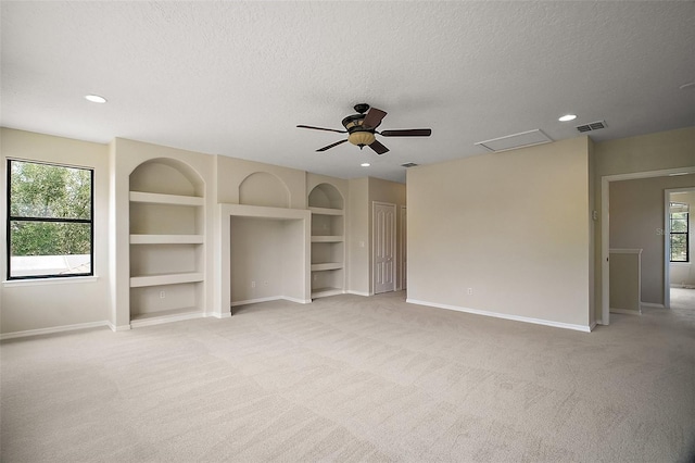 21206 Canoe Pass St, Clermont, FL 34715 - unfurnished bedroom featuring baseboards, a textured ceiling, light colored carpet, attic access, and ceiling fan