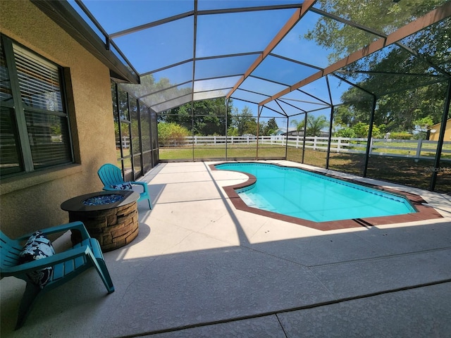 21206 Canoe Pass St, Clermont, FL 34715 - view of swimming pool featuring a patio area, glass enclosure, and a fire pit