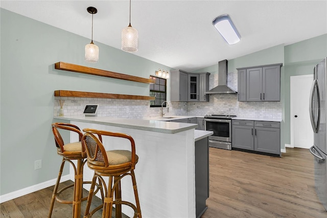717 SE 46th Ct, Ocala, FL 34471 - kitchen featuring appliances with stainless steel finishes, wall chimney range hood, gray cabinetry, open shelves, and lofted ceiling