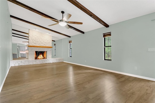 717 SE 46th Ct, Ocala, FL 34471 - unfurnished living room with a ceiling fan, a fireplace, and wood finished floors