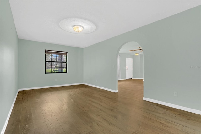 717 SE 46th Ct, Ocala, FL 34471 - empty room with arched walkways and wood finished floors