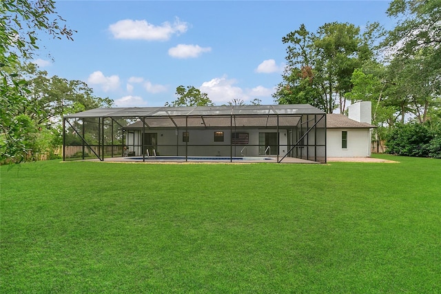 717 SE 46th Ct, Ocala, FL 34471 - rear view of house featuring a lawn, a patio area, an outdoor pool, and a chimney