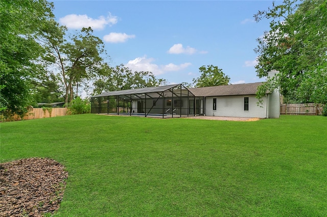 717 SE 46th Ct, Ocala, FL 34471 - rear view of house with a fenced backyard, a lanai, a patio, brick siding, and a chimney