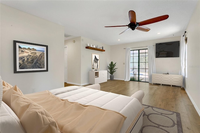 717 SE 46th Ct, Ocala, FL 34471 - bedroom with wood finished floors, ceiling fan, and recessed lighting