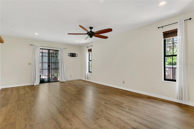 717 SE 46th Ct, Ocala, FL 34471 - empty room with plenty of natural light, wood finished floors, a ceiling fan, a textured ceiling, and recessed lighting