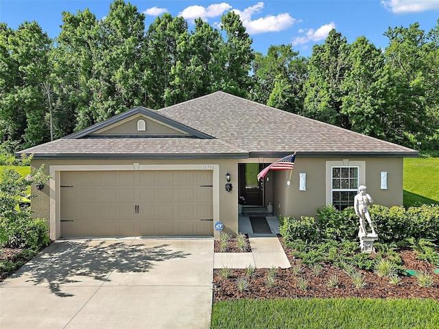 12952 Del Lago Dr, Astatula, FL 34705 - ranch-style home with roof with shingles, stucco siding, and a garage