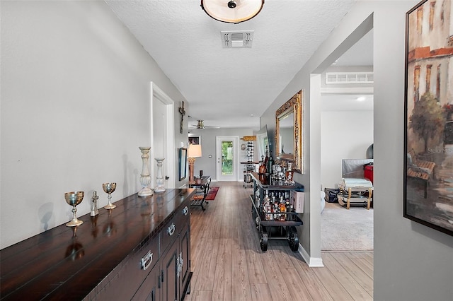 12952 Del Lago Dr, Astatula, FL 34705 - corridor featuring light wood-style flooring and baseboards